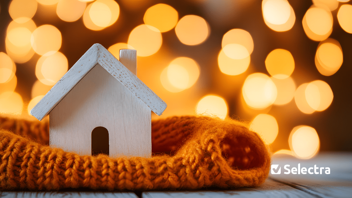 Image with a miniature house covered in a knitted scarf 
